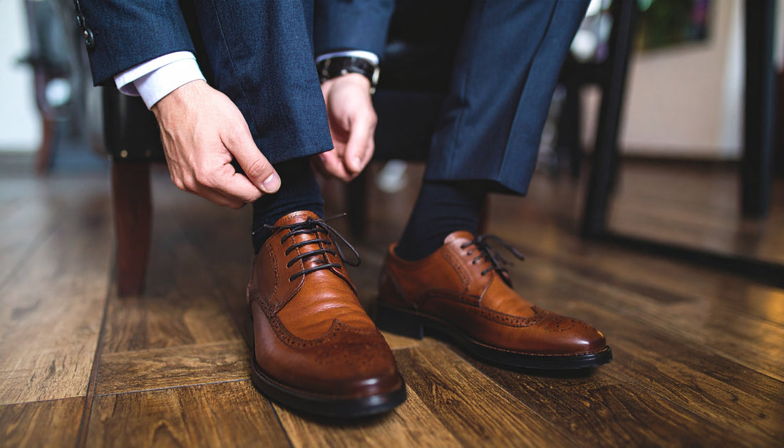 A sophisticated lifestyle image showcasing a man wearing a pair of stylish Rumani Shoes, with a focus on the shoe's detail and craftsmanship.