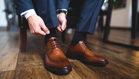 A sophisticated lifestyle image showcasing a man wearing a pair of stylish Rumani Shoes, with a focus on the shoe's detail and craftsmanship.